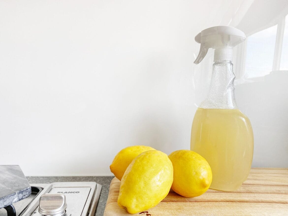 lemons and a bottle with a cleaning solution in it