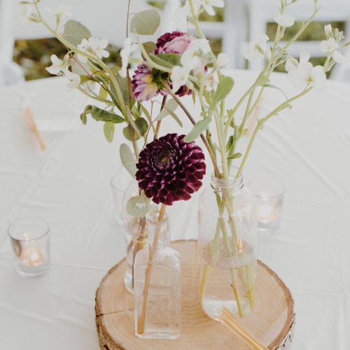 wedding decoration center piece with flowers on a piece of wood